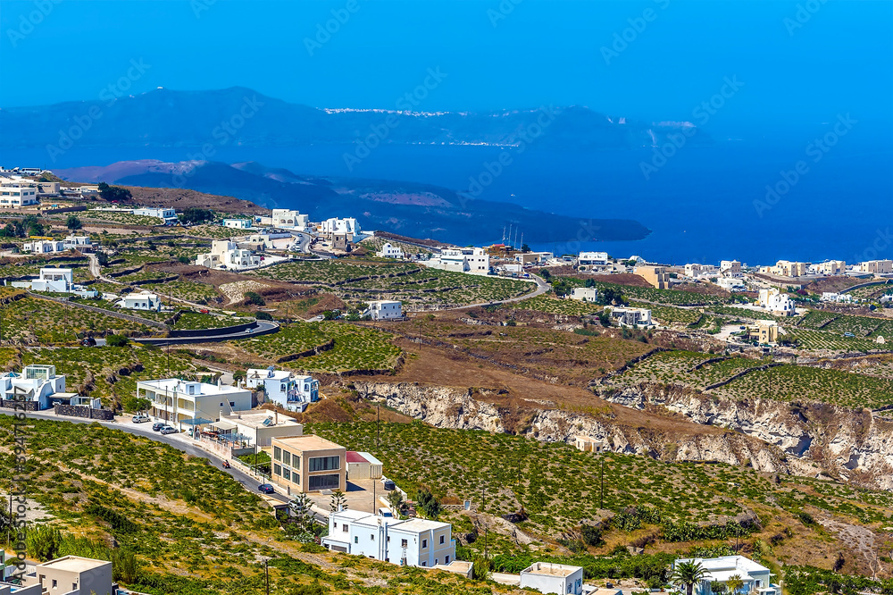 A view down from the castle ruins in Pyrgos, Santorini over the surrounding countryside in summertime