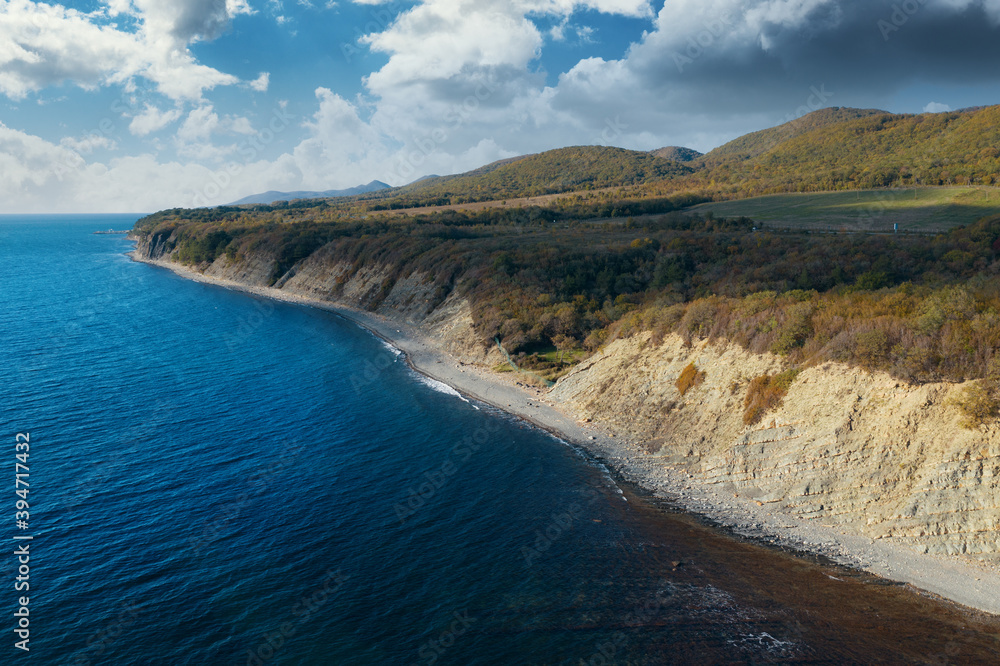 Aerial view of blue sea coast and rock cliffs. Black sea, wild nature, drone flight above water.