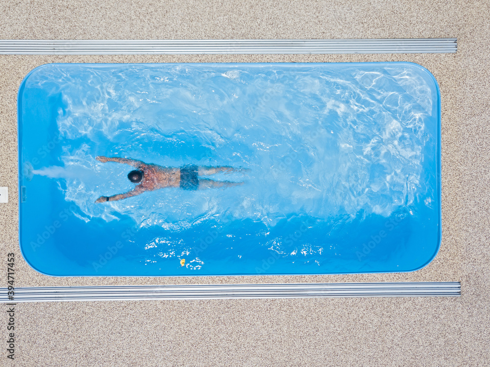A young man enjoys summer fun by the hotel pool.