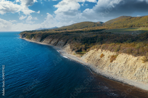 Aerial view of blue sea coast and rock cliffs. Black sea  wild nature  drone flight above water.