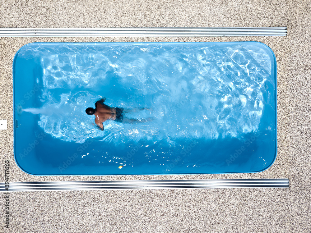 A young man enjoys summer fun by the hotel pool.