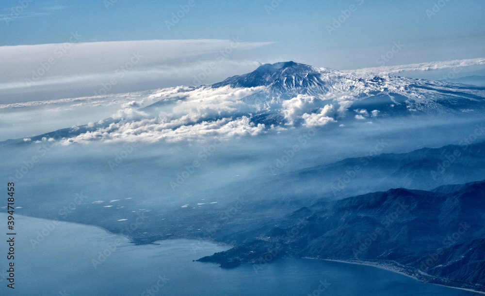 view from the airplane window of the mountains and clouds. view from the airplane window of the mountains and clouds.