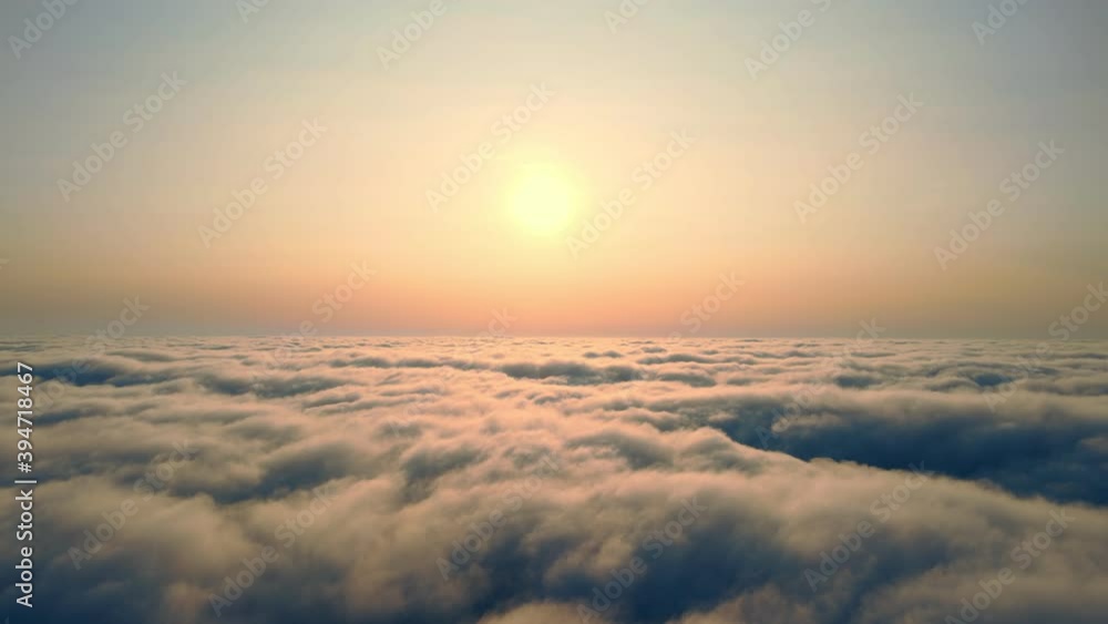 Flying over the clouds at sunset. The sun rises over the fog. Orange sunset over the fog. Flying over the clouds at sunset. The sun rises over the fog. Orange sunset over the fog.