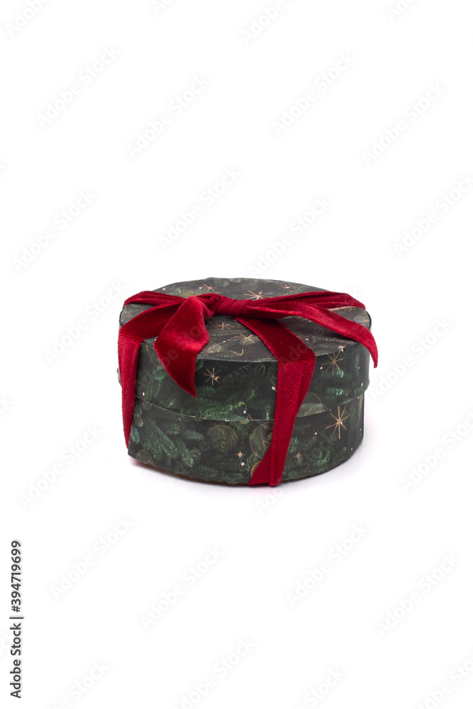 New Year's gift in green packaging with a red bow on a white background