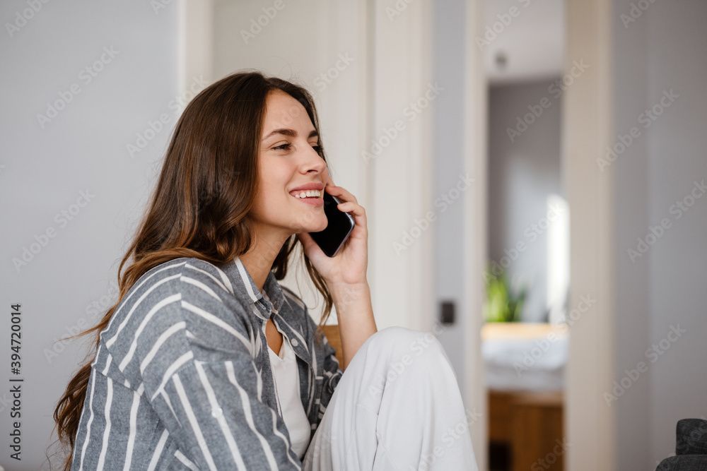 Happy beautiful woman smiling and talking on cellphone Happy beautiful woman smiling and talking on cellphone