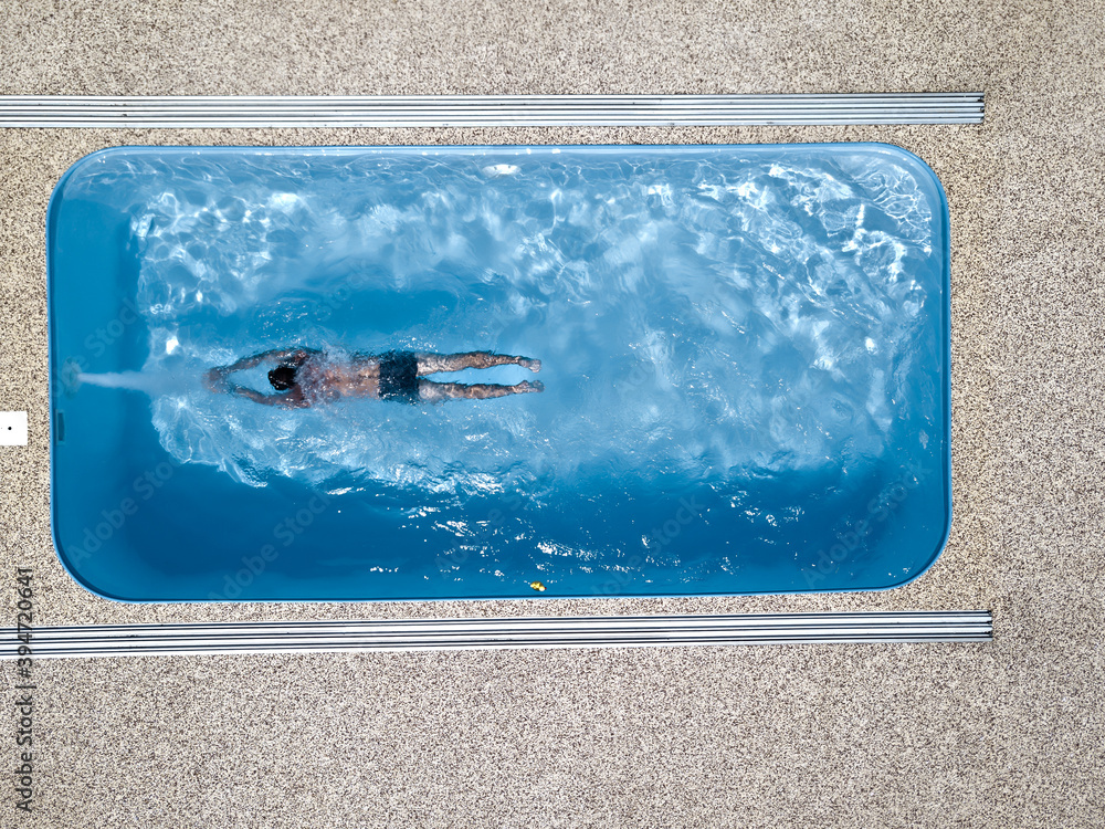 A young man enjoys summer fun by the hotel pool.
