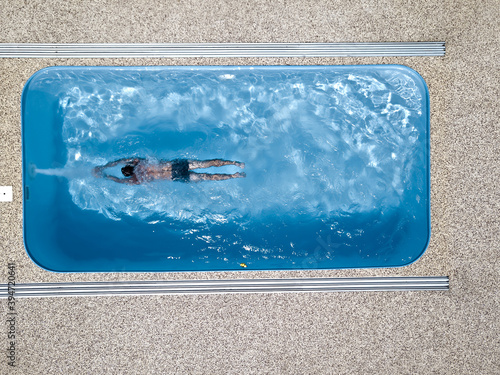 A young man enjoys summer fun by the hotel pool.