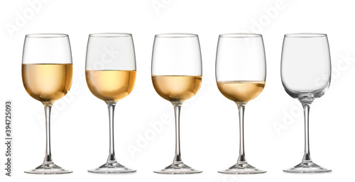 Glasses with different amount of wine on white background