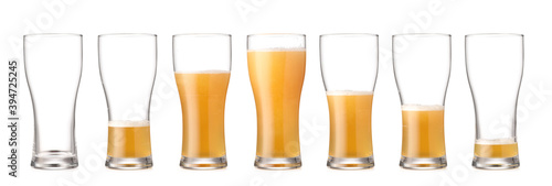 Glasses with different amount of beer on white background