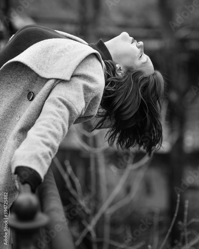Brunette girl has bent back on the bridge in city. Plus size model