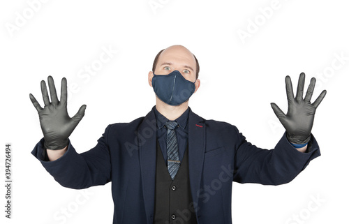 Surprised or scared business man with surgical medical virus protection mask and black gloves isolated.