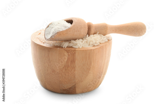 Bowl with rice and scoop with flour on white background