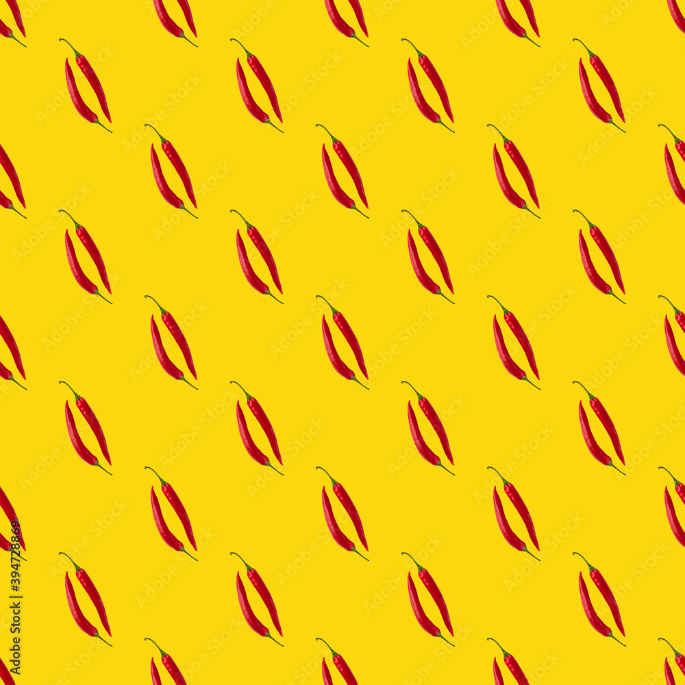 Seamless pattern made of isolated two red chili peppers on yellow background. Top view. Food flatlay. Seamless pattern made of isolated two red chili peppers on yellow background. Top view. Food flatlay.