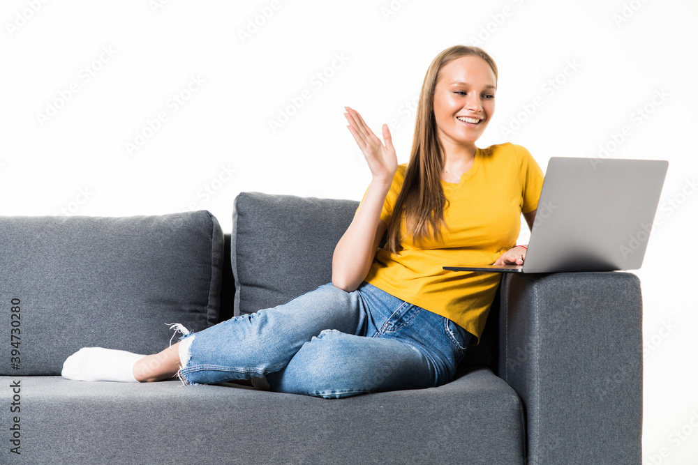 Excited young woman in casual clothes sitting on couch spending time isolated on white background . Excited young woman in casual clothes sitting on couch spending time isolated on white background .