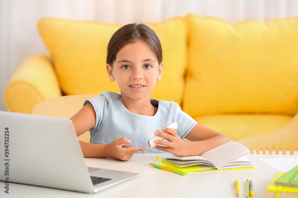 Little diabetic girl checking blood sugar level at home Little diabetic girl checking blood sugar level at home