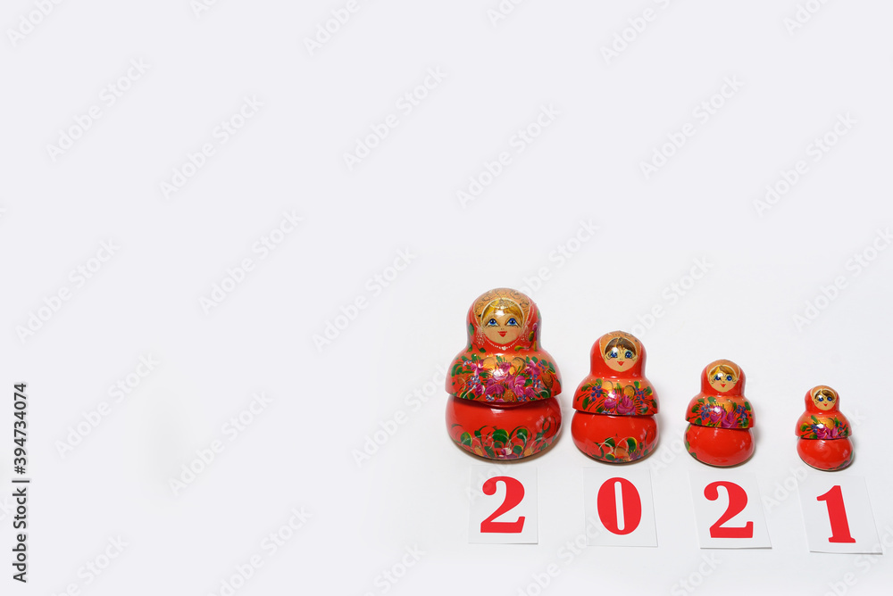 red christmas numbers 2021 combined with russian nesting dolls on isolated white background. russian doll matryoshka Holiday decoration or postcard concept with top view and copy spac