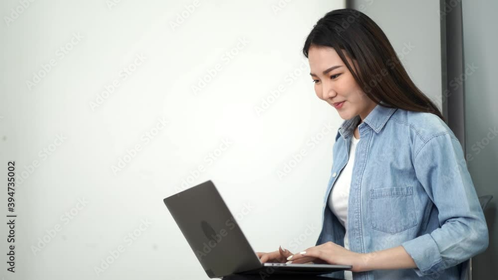 Happy young asian woman sitting at cafe looking on the screen, Online media studying. Happy young asian woman sitting at cafe looking on the screen, Online media studying.