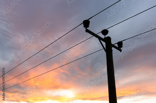 Utility pole against a sunset background