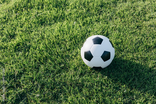 Soccer ball on grass field, sport concept. © Kannapat