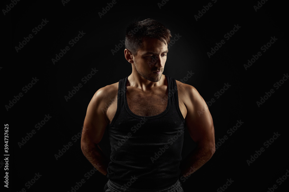 Muscular sporty young man on black backgrround