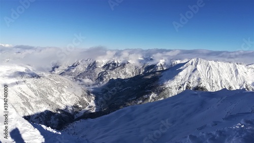 View of the snowy Alps. Snowy mountain peaks. Amazing panorama of rocky mountains in winter. photo