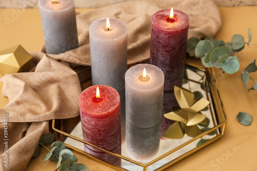 Tray with beautiful aroma candles on table