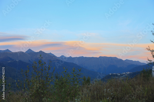 Beautiful bright panorama of the mountain landscape at sunset against the background of the blue sky