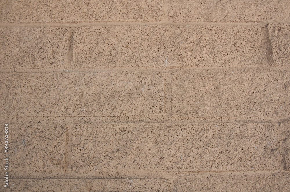Fototapeta premium Tan brick wall great for backgrounds, textures and design elements.