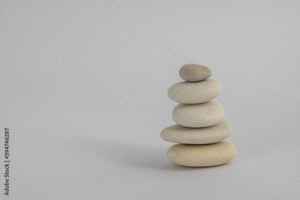 One simplicity stones cairn isolated on white background, group of five white pebbles in tower One simplicity stones cairn isolated on white background, group of five white pebbles in tower