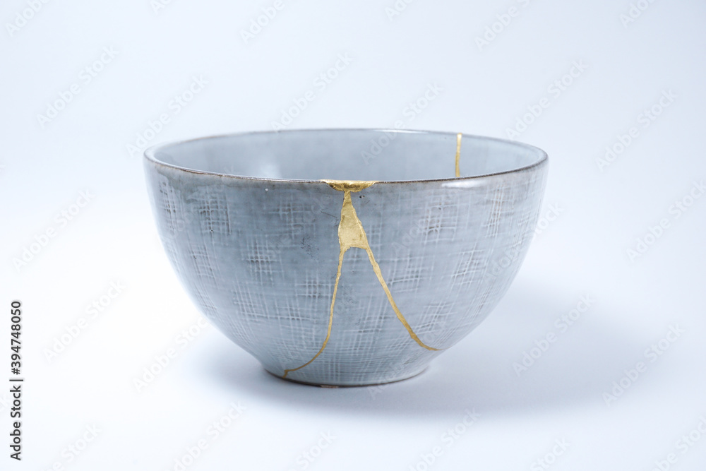 Kintsugi Japanese grey bowl. Gold cracks restoration on pottery ...
