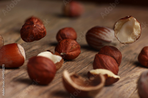 hazelnuts falling on a structural table made of cracked wood