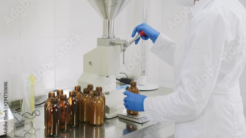 Cosmetology expert doctor chemist scientist pharmacist making medicine cosmetic in the laboratory. pouring and measure natural liquid lotion serum.Manufacture of cosmetics and perfumes.