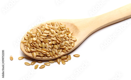 Golden flax seeds, linseed in wooden spoon isolated on white background