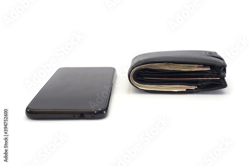 black smartphone and black men's wallet on a white
