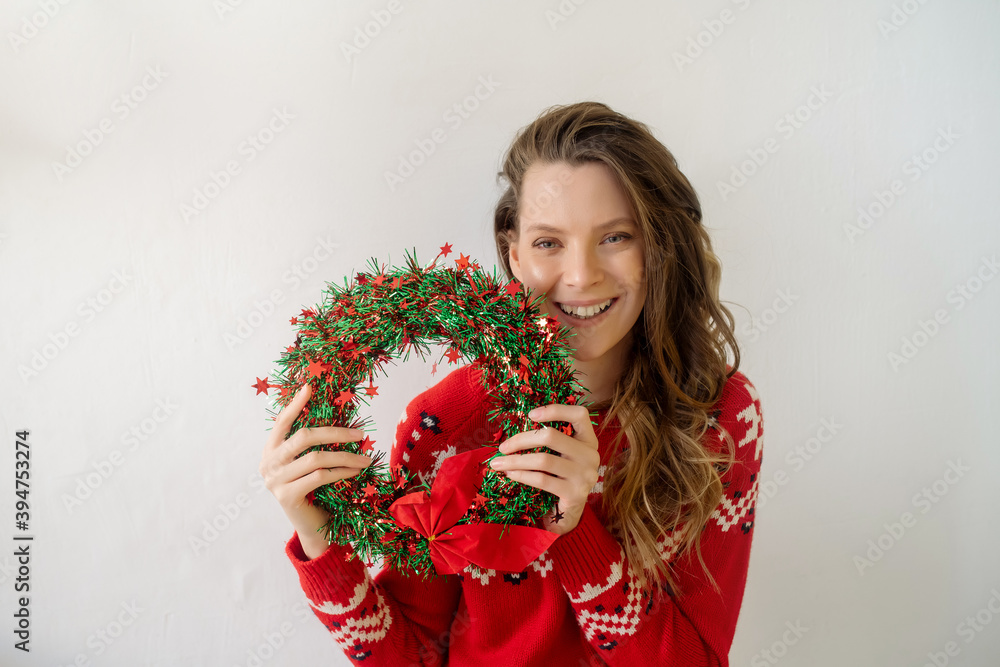 A young Caucasian woman with long curly hair in a New Year's sweater is wrapped in a plaid and is freezing in the cold season. Isolated on white background
A young Caucasian woman with long curly hair in a New Year's sweater is wrapped in a plaid and is freezing in the cold season. Isolated on white background