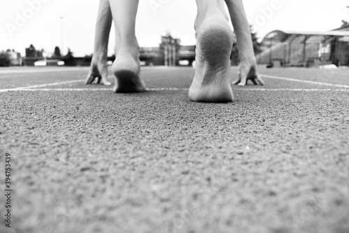 Close-up of barefoot athlete ready for initial shot - Black and white