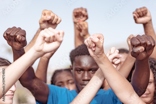 People raised fist air fighting for their rights. Labor movement, election movement, no racism, no lockdown, no coronavirus (covid 19), deniers and union concept.
