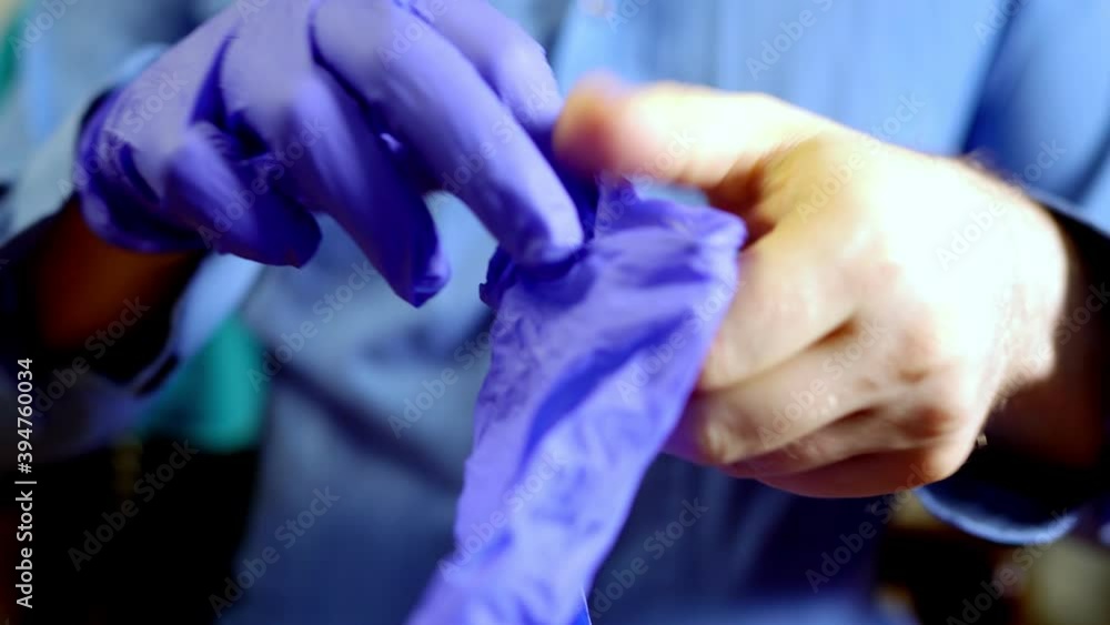 Man puts on his medical gloves. Covid-19 prevention. Man puts on his medical gloves. Covid-19 prevention.