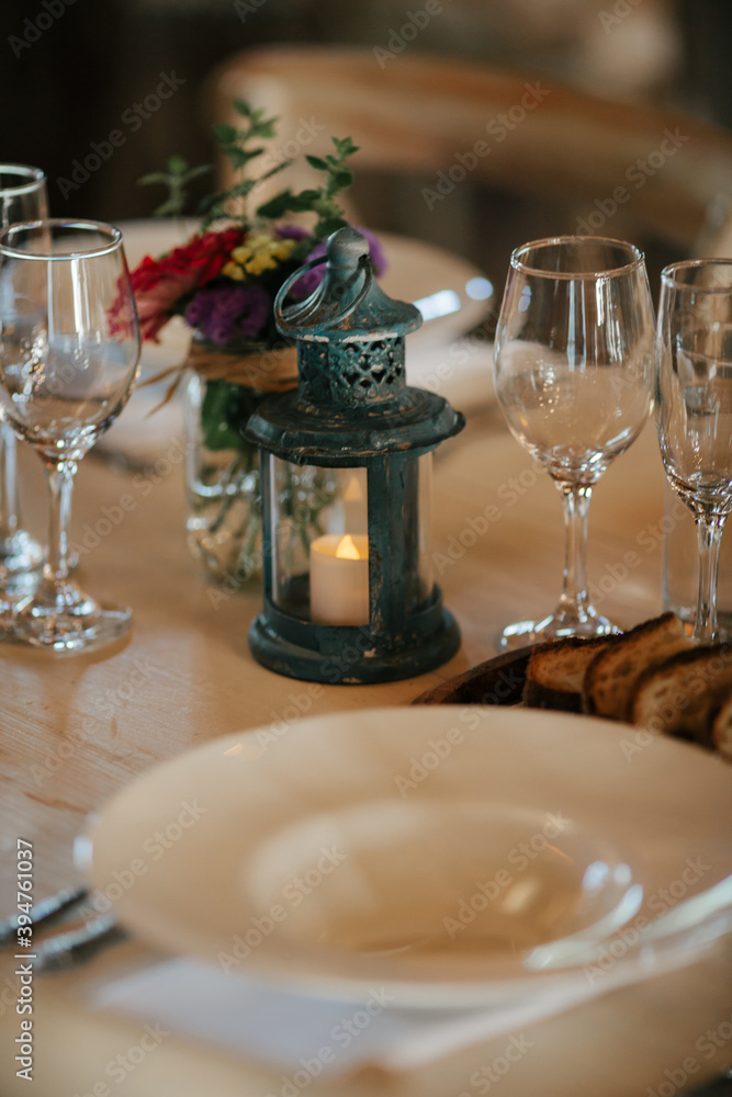 table setting with lantern and wineglasses table setting with lantern and wineglasses