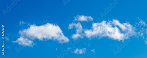 White clouds on a blue sky in bright colors  panorama