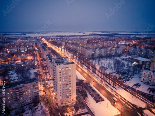 Aerial city winter view with crossroads and roads, houses, buildings, parks. Helicopter drone shot. Wide Panoramic image. Kharkiv, Ukraine © Kotangens