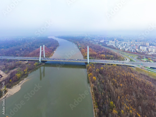 Aerial drone view. bridge  in the rays of a sunny morning. Autumn haze in the air  cars are driving across the bridge.