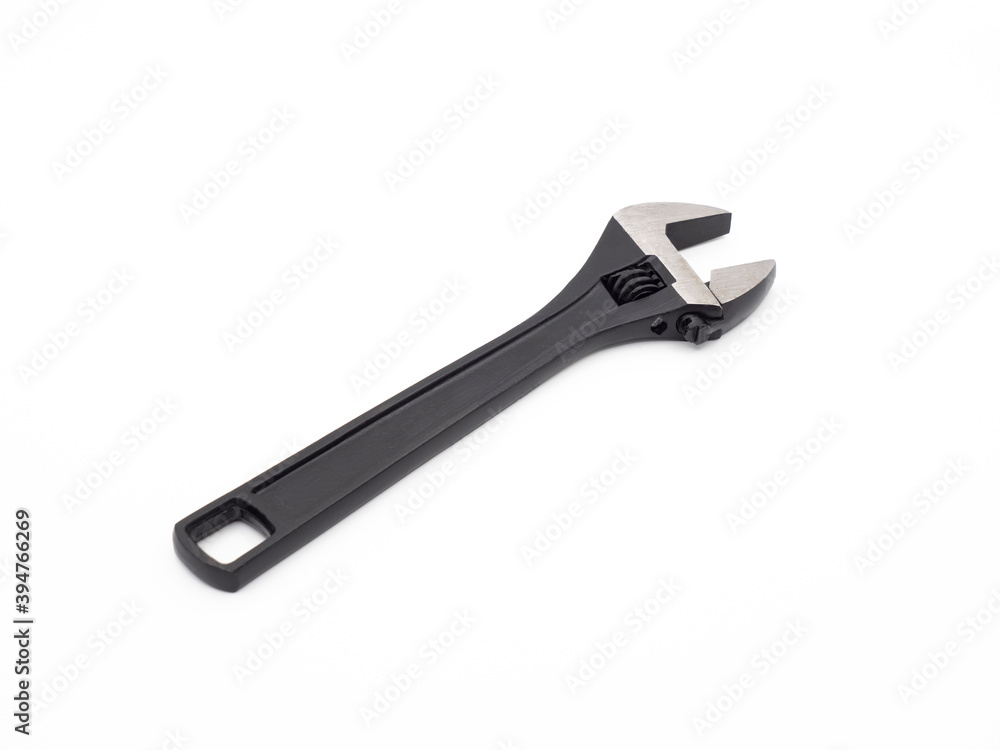 Black open adjustable wrench on a light background Black open adjustable wrench on a light background