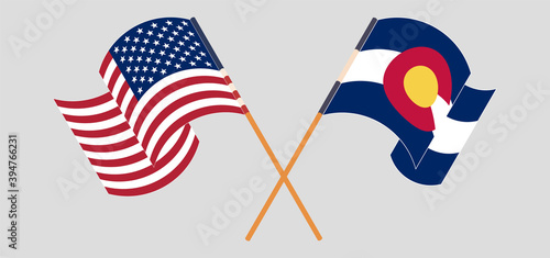 Crossed and waving flags of The USA and The State of Colorado