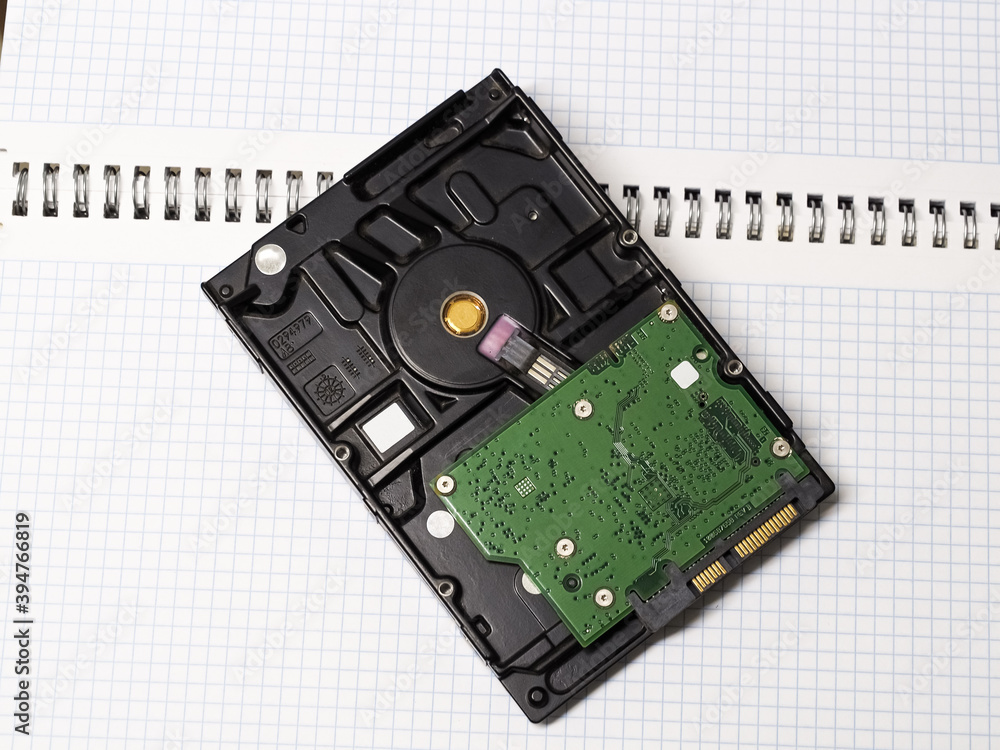 Dusty closed hard drive on a notebook in a cage Dusty closed hard drive on a notebook in a cage
