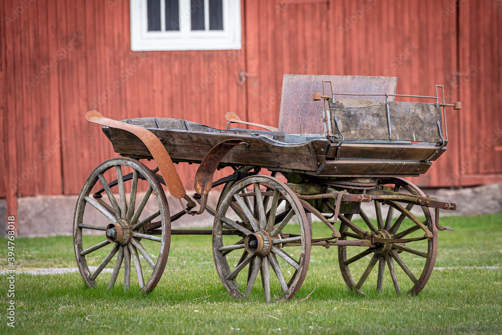 Image of the old wooden horse cart on the grass 