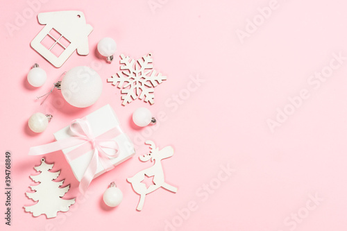Christmas pink flat lay background with holiday decorations. © nadianb
