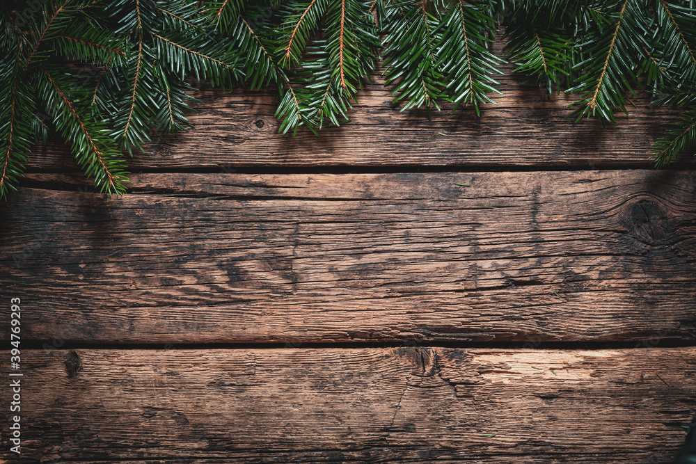 Christmas decoration background. Green fir branches on a rustic aged wooden wall. Space for copy. Christmas decoration background. Green fir branches on a rustic aged wooden wall. Space for copy.
