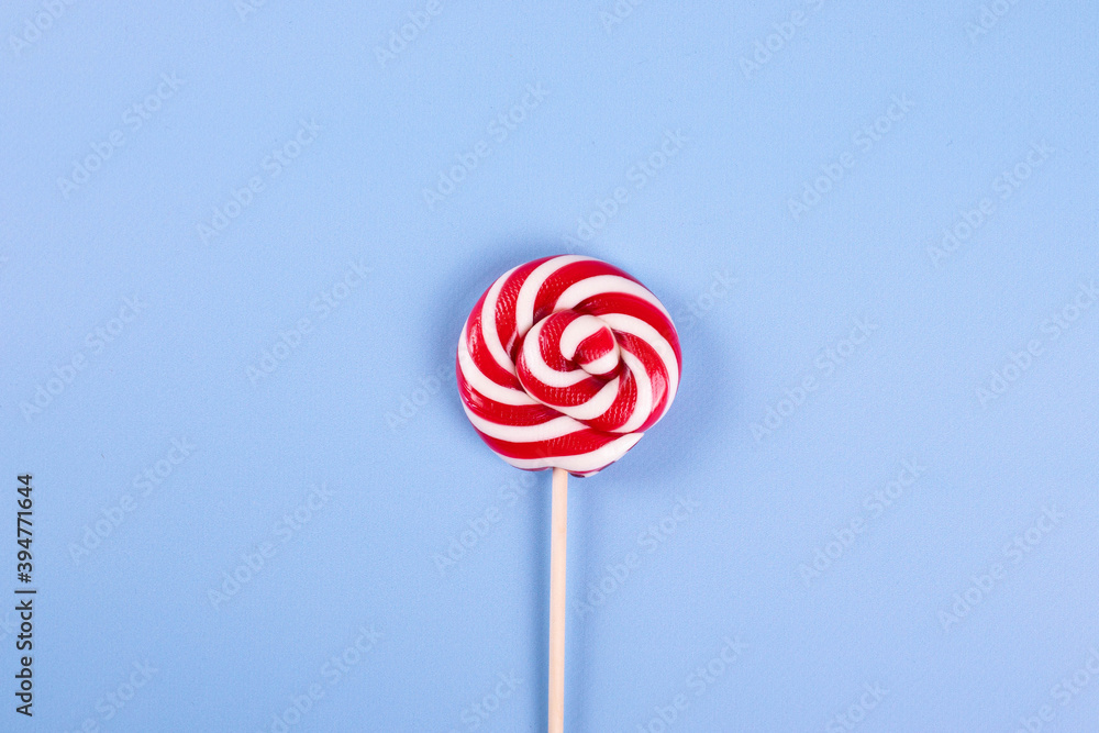 sweet yummy festive colorful lollipops on light blue background. copy space for text. minimalism style sweet yummy festive colorful lollipops on light blue background. copy space for text. minimalism style