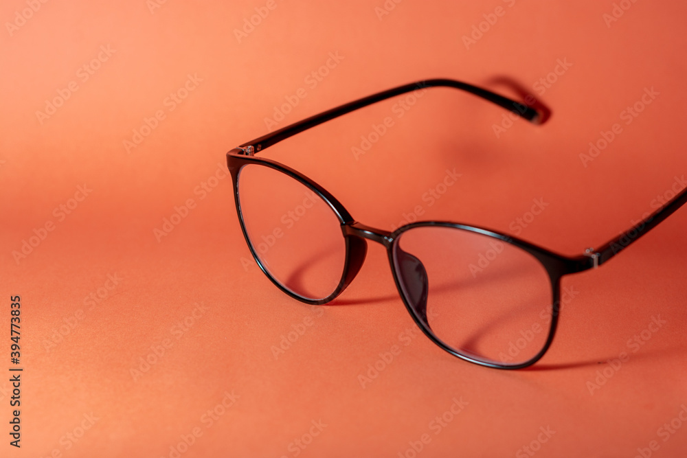 glasses on a orange table background
